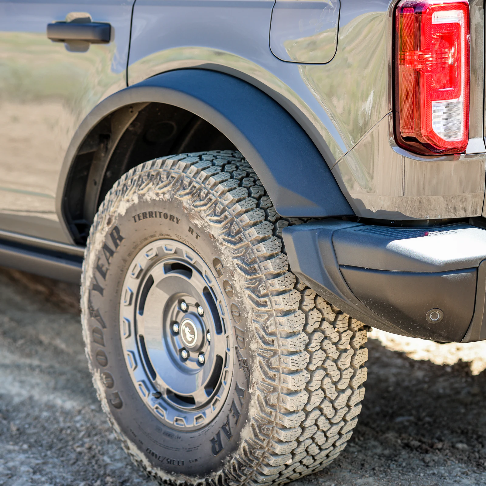 Canon EOS R8 close-up of a trail-dusted Ford Bronco tire and tail lamp.