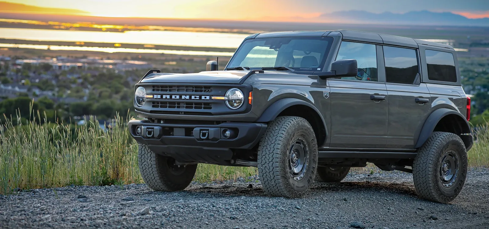 Wide Canon EOS R8 view of a Ford Bronco on a canyon ridgeline at sunset in Bountiful Canyon, Utah.